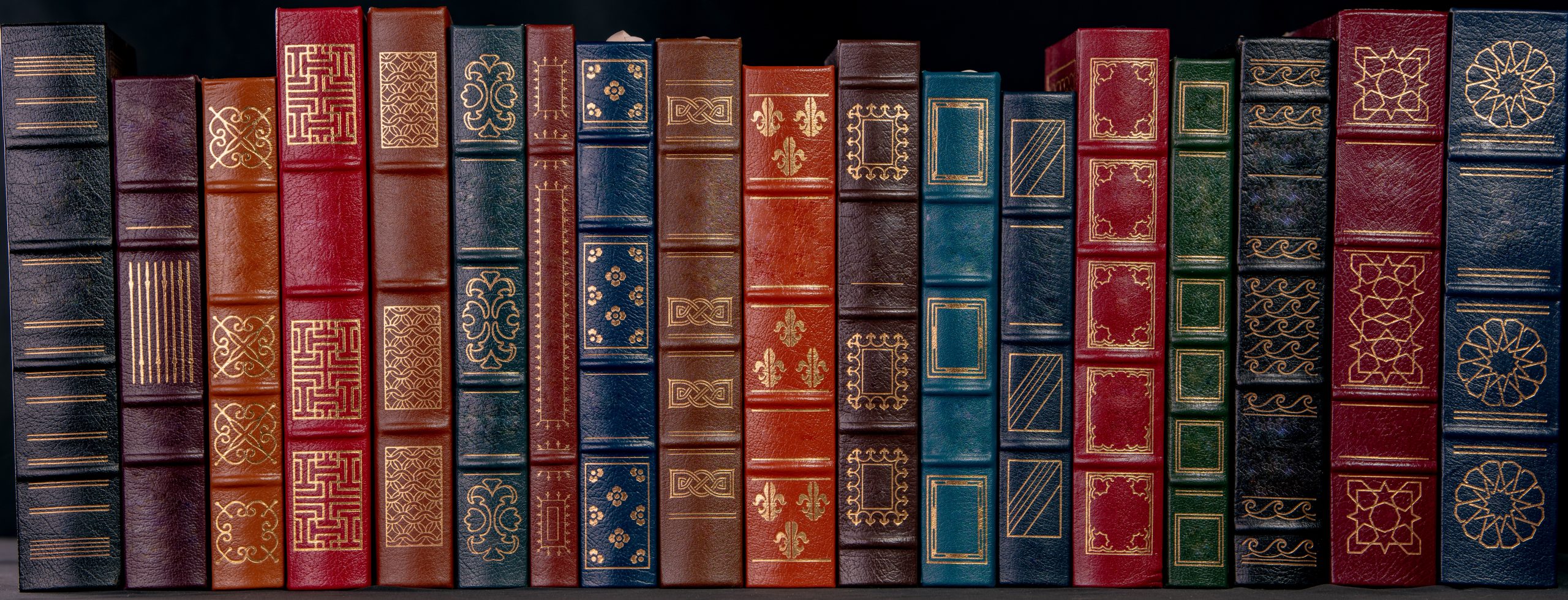 A stack of beautiful leather bound books with golden decoration