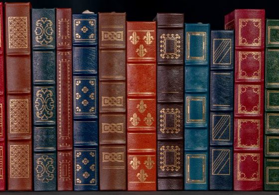 A stack of beautiful leather bound books with golden decoration A stack of beautiful leather bound books with golden decoration